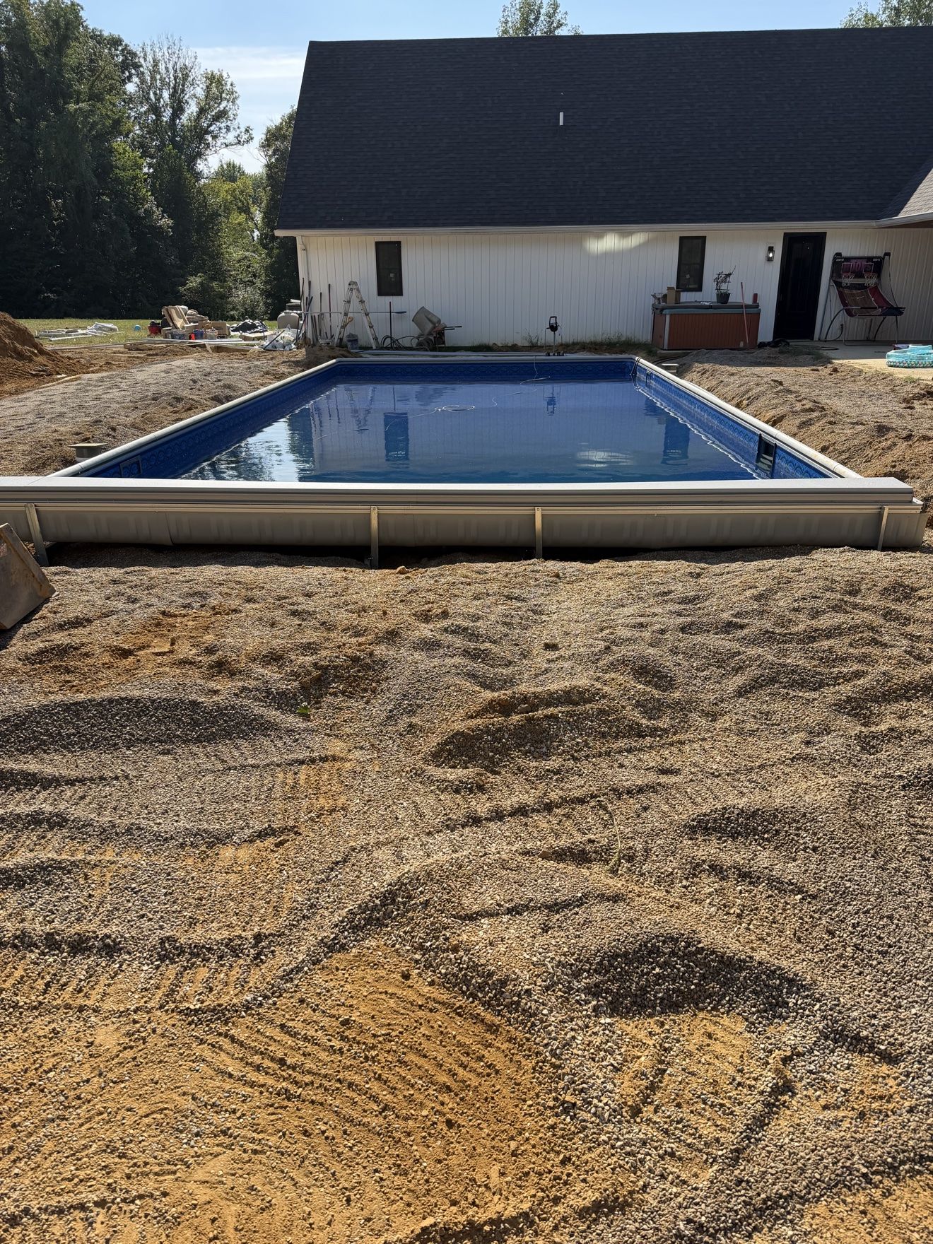 New inground pool with the liner in and filled, looking toward the house
