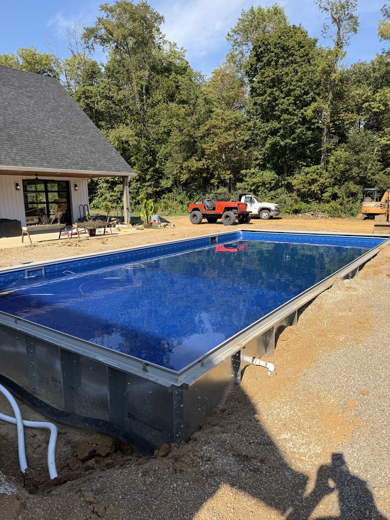 Finished inground pool build with new liner in and filled with blue water